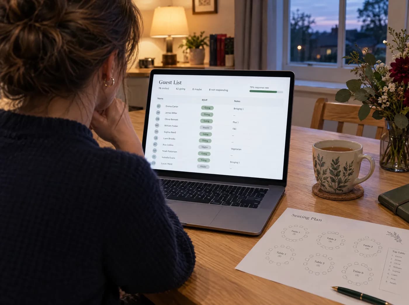 A host at a kitchen table reading a guest list that shows who is going, who might come and dietary notes
